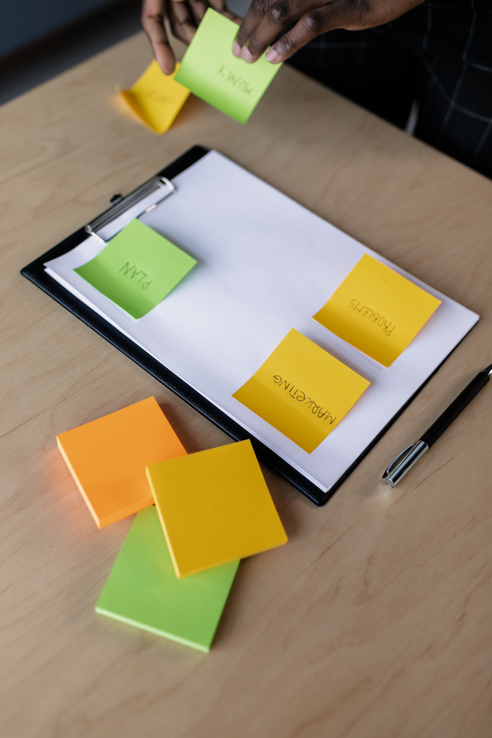 Clipboard with Paper Beside a Black Pen